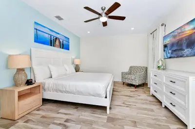 a bedroom with a white bed and a ceiling fan at Lime Green Villa Near Disney With Margaritaville Resort & Island H20 Waterpark Access - 2930Cl in Orlando