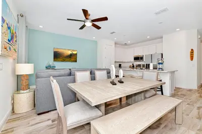a dining room and kitchen with a table and a couch at Sea Blue Villa Near Disney With Margaritaville Resort & Island H20 Access - 3164Cs in Orlando