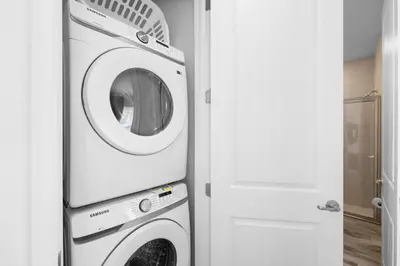 a washer and dryer in a room next to a door at Lime Green Villa Near Disney With Margaritaville Resort & Island H20 Waterpark Access - 2965Cs in Orlando
