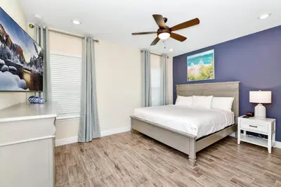 a bedroom with a bed and a ceiling fan at Palm Tree Paradise Villa Near Disney With Margaritaville Resort & Island H20 Waterpark Access - 3113Cs in Orlando