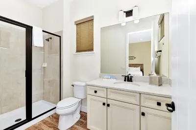 a bathroom with a toilet and a sink and a shower at The Pearl Cottage Near Disney With Margaritaville Resort & Island H20 Waterpark Access - 3078Pi in Orlando