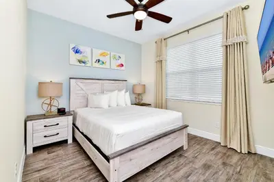 a bedroom with a bed and a ceiling fan at Sunny Villa Near Disney With Margaritaville Resort & Island H20 Access - 8111Cp in Orlando