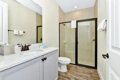 a white bathroom with a toilet and a sink at Sunny Villa Near Disney With Margaritaville Resort & Island H20 Access - 8111Cp in Orlando