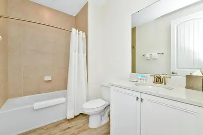 a bathroom with a toilet and a sink and a shower at Serene Villa Near Disney With Margaritaville Resort Island H20 Access - 8167Cp in Orlando