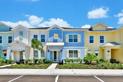 a row of houses with blue and yellow at Welcoming Villa Near Disney With Margaritaville Resort & Island H20 Waterpark Access - 2943Cl in Orlando