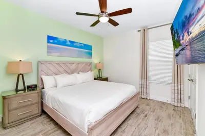 a bedroom with a bed and a ceiling fan at Paradise Villa Near Disney With Margaritaville Resort & Island H20 Access - 8186Cp in Kissimmee