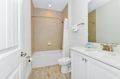 a white bathroom with a toilet and a sink at Colorful Villa Near Disney With Margaritaville Resort & Island H20 Waterpark Access- 2919Cl in Orlando