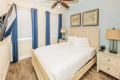a bedroom with a bed and a ceiling fan at Flip Flops And Tank Tops Cottage With Private Pool Near Disney With Margaritaville Resort & Island H2O Access - 8098Kd in Orlando