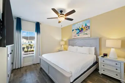 a bedroom with a bed and a ceiling fan at Cozy Villa Near Disney With Margaritaville Resort & Island H20 Waterpark Access - 3009Cs in Orlando