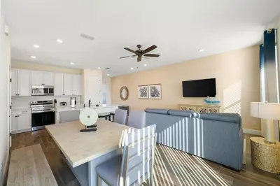 a kitchen and dining room with a table and a couch at Cozy Villa Near Disney With Margaritaville Resort & Island H20 Waterpark Access - 3009Cs in Orlando