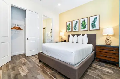 a bedroom with a large bed and a closet at Waters Edge Cottage Near Disney With Margaritaville Resort & Island H20 Access - 8129Su in Orlando