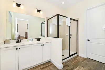 a bathroom with two sinks and a shower at Waters Edge Cottage Near Disney With Margaritaville Resort & Island H20 Access - 8129Su in Orlando