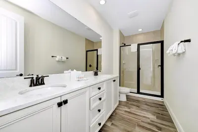 a white bathroom with a sink and a toilet at Citrus Sunshine Villa Near Disney With Margaritaville Resort & Island H2O Access - 3049Cs in Orlando