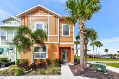 a house with palm trees in front of it at Citrus Sunshine Villa Near Disney With Margaritaville Resort & Island H2O Access - 3049Cs in Orlando