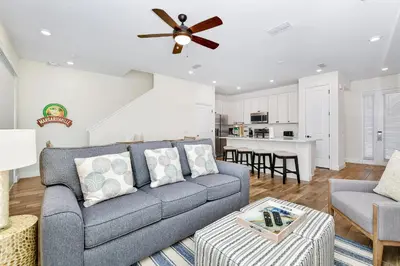a living room with a couch and a ceiling fan at Colorful Villa Near Disney With Margaritaville Resort & Island H20 Access - 8195Cp in Kissimmee
