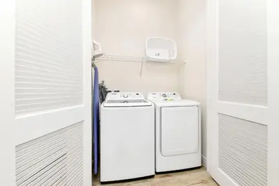 a small kitchen with a stove and a refrigerator at Sandy Toes Cottage With Private Pool Near Disney And Margaritaville Resort & Island H2O Access - 8032St in Orlando