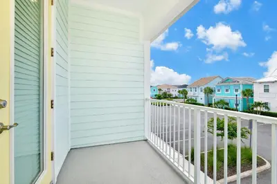 a balcony with a view of a house at Sandy Toes Cottage With Private Pool Near Disney And Margaritaville Resort & Island H2O Access - 8032St in Orlando