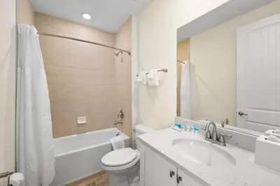 a white bathroom with a sink and a toilet at Caribbean Dream Villa Near Disney With Margaritaville Resort & Island H20 Waterpark Access - 2980Or in Orlando