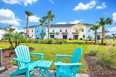 two blue chairs sitting in front of a house at Lime Green Villa Near Disney With Margaritaville Resort & Island H20 Waterpark Access - 2972Or in Orlando
