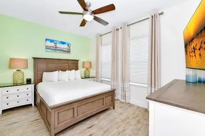 a bedroom with a bed and a ceiling fan at Pink Villa Near Disney With Margaritaville Resort & Island H20 Access - 8163Cp in Orlando