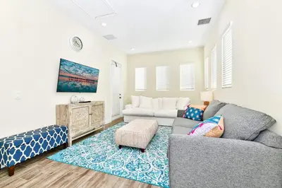 a living room with a couch and a table at Sunny Cottage With Private Pool Near Disney With Margaritaville Resort & Island H2O Access - 8021Kd in Orlando