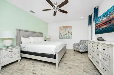 a bedroom with a bed and a ceiling fan at Beautiful Waterfront Villa Near Disney With Margaritaville Resort & Island H20 Waterpark Access - 3017Cs in Orlando