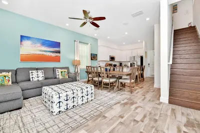 a living room with a couch and a table at The Tipsy Turtle Cottage With Private Pool Near Disney With Margaritaville Resort & Island H2O Access - 8012St in Orlando