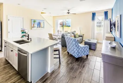 a kitchen and living room with a couch and a table at Breezy Villa Near Disney With Margaritaville Resort & Island H20 Access - 8177Su in Orlando