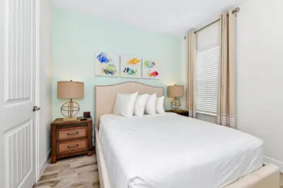 a bedroom with a white bed and a window at Lime Green Villa Near Disney With Margaritaville Resort & Island H20 Waterpark Access - 2958Cl in Orlando