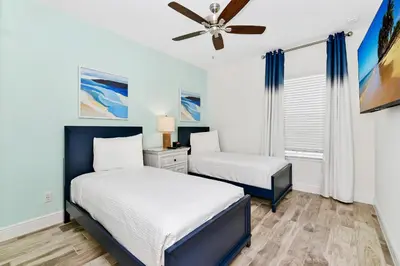 a bedroom with two beds and a ceiling fan at Lovely Villa Near Disney With Margaritaville Resort & Island H20 Waterpark Access - 2956Or in Orlando
