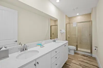 a white bathroom with two sinks and a shower at Tropical Villa Near Disney With Margaritaville Resort & Island H20 Waterpark Access - 2945Cs in Orlando