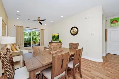 a dining room with a table and chairs at Orange Creamsickle Cottage Near Disney With Margaritaville Resort & Island H20 Waterpark Access - 2980Sr in Orlando