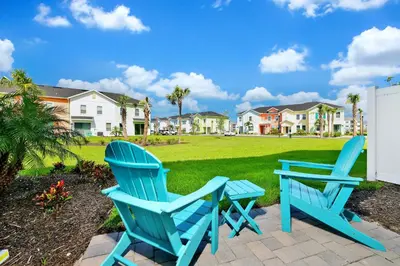 two blue chairs and a table in a yard at Glimmering Blue Villa Near Disney With Margaritaville Resort & Island H20 Waterpark Access - 3016Cs in Orlando