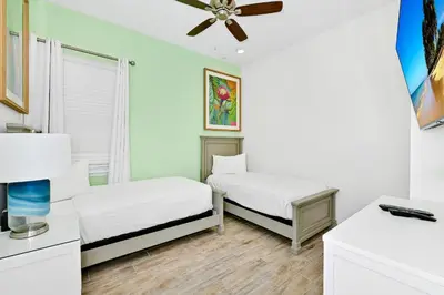 a bedroom with two beds and a ceiling fan at Blue Haven Cottage Near Disney With Margaritaville Resort & Island H20 Waterpark Access - 7996Ls in Orlando