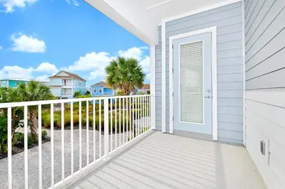 a door to a balcony with a view of the ocean at Blue Haven Cottage Near Disney With Margaritaville Resort & Island H20 Waterpark Access - 7996Ls in Orlando