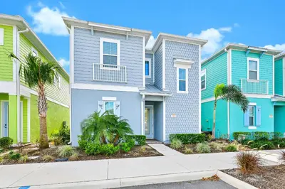 a row of houses with palm trees in front at Blue Haven Cottage Near Disney With Margaritaville Resort & Island H20 Waterpark Access - 7996Ls in Orlando