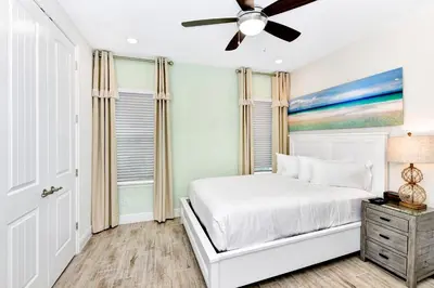 a bedroom with a bed and a ceiling fan at Sun Filled Villa Near Disney With Margaritaville Resort & Island H20 Access - 8183Cp in Kissimmee
