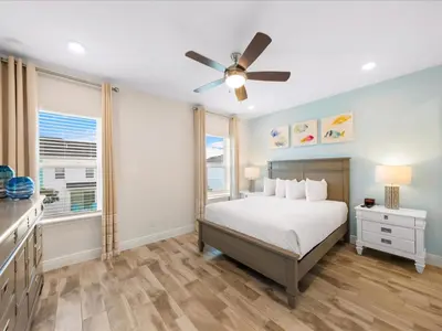 a bedroom with a bed and a ceiling fan at Bright Villa Near Disney With Margaritaville Resort & Island H20 Access - 8159Cp in Orlando