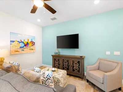 a living room with a couch and a flat screen tv at Bright Villa Near Disney With Margaritaville Resort & Island H20 Access - 8159Cp in Orlando