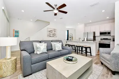 a living room with a couch and a table at Sunny Villa Near Disney With Margaritaville Resort & Island H20 Access - 8151Cp in Orlando