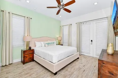 a bedroom with a bed and a ceiling fan at Cozy Cottage With Private Pool Near Disney With Margaritaville Resort & Island H2O Access - 8028Kd in Orlando