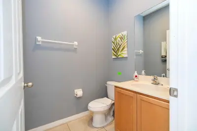 a bathroom with a toilet and a sink at Cozy 2Bd Spa & Jacuzzi Close to Disney at Encantada 3029 in Kissimmee