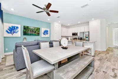 a kitchen and dining room with a table and a couch at Bright Blue Villa Near Disney With Margaritaville Resort & Island H20 Waterpark Access - 3085Cs in Orlando