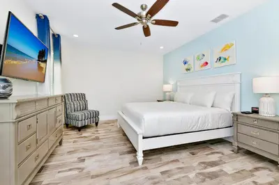 a bedroom with a white bed and a ceiling fan at Bright Blue Villa Near Disney With Margaritaville Resort & Island H20 Waterpark Access - 3085Cs in Orlando