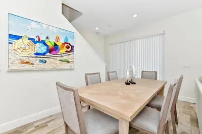 a dining room with a wooden table and chairs at Blissful Villa Near Disney With Margaritaville Resort & Island H20 Waterpark Access - 3109Cs in Orlando