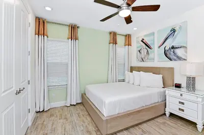 a bedroom with a bed and a ceiling fan at Tropical Villa Near Disney With Margaritaville Resort & Island H20 Waterpark Access - 3180Cs in Orlando