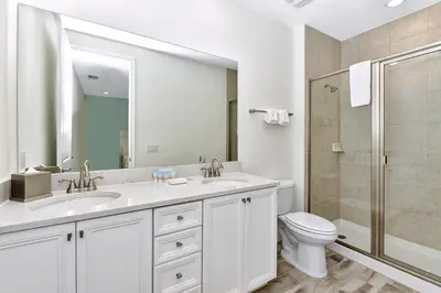 a bathroom with two sinks and a toilet and a shower at Pleasant Villa Near Disney With Margaritaville Resort & Island H20 Access - 2916Or in Orlando