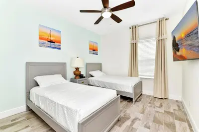 a bedroom with two beds and a ceiling fan at Spacious Villa Near Disney With Margaritaville Resort & Island H20 Waterpark Access - 2938Cl in Orlando