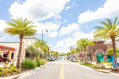 a street in a town with palm trees at Tangerine Villa Near Disney With Margaritaville Resort & Island H20 Waterpark Access - 2968Cs in Orlando