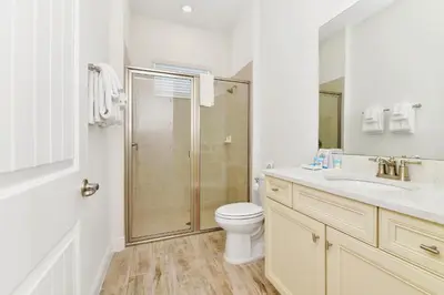 a bathroom with a shower and a toilet and a sink at White Sand Cottage With Private Pool Near Disney With Margaritaville Resort & Island H2O Access - 8023Kd in Orlando